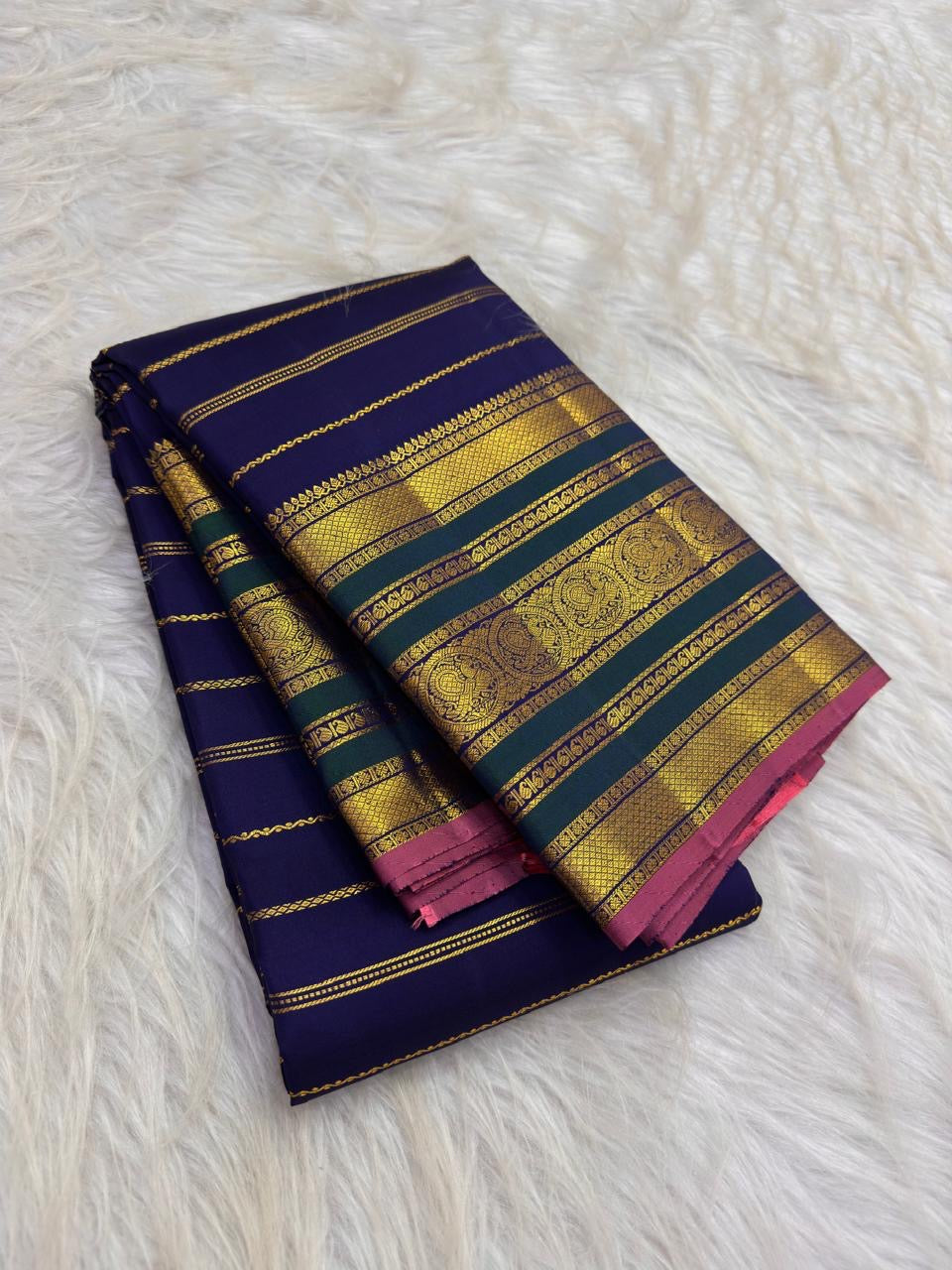Royal blue Kanchipuram silk showing Veldhari zari bands across the body.