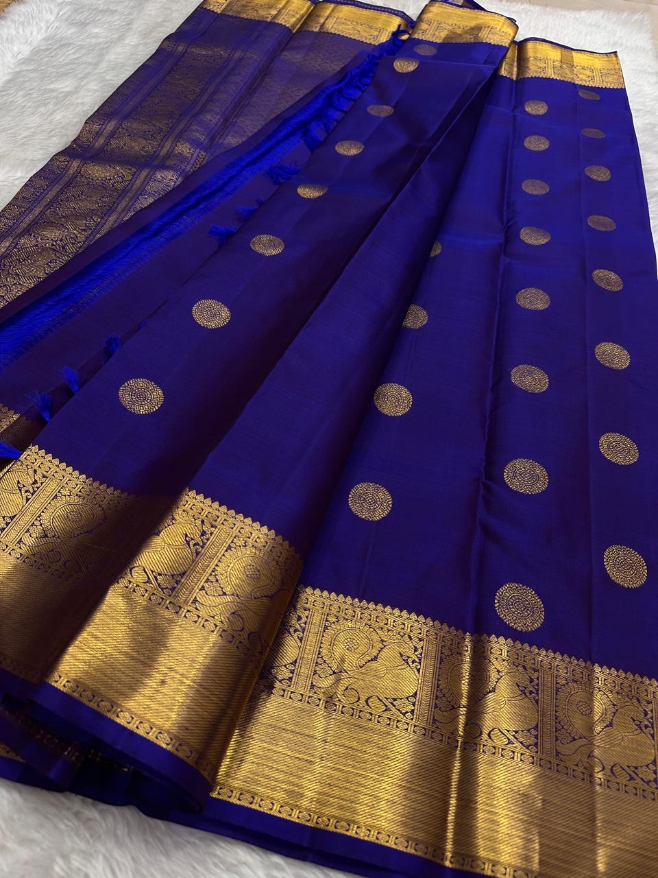Handwoven royal blue Kanjivaram Butta saree with traditional gold zari ornamentation.