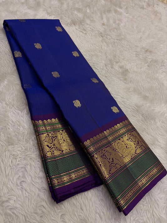 Royal blue Kanjivaram silk saree with traditional gold zari detailing.