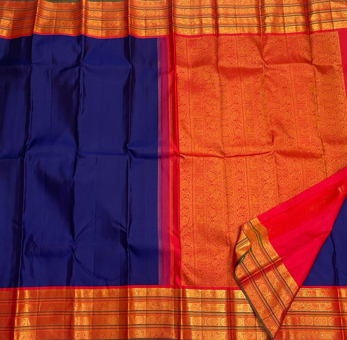 Handwoven royal-blue Pure Silk Kanchipuram Varisaipet saree with a warm burnt-orange zari border.