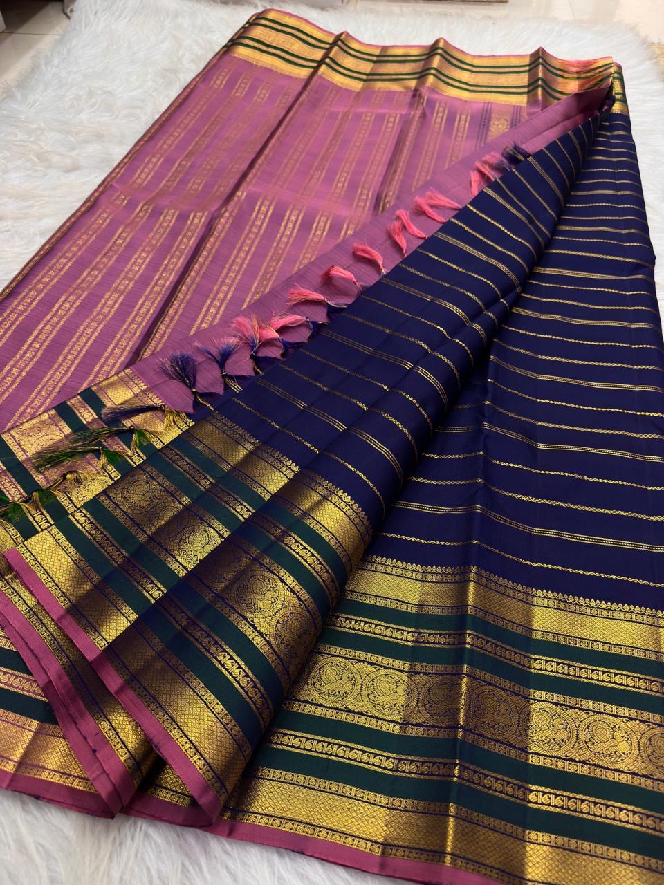 Royal blue Kanjivaram Varisaipet saree showing the deep-green border and pink-purple pallu.