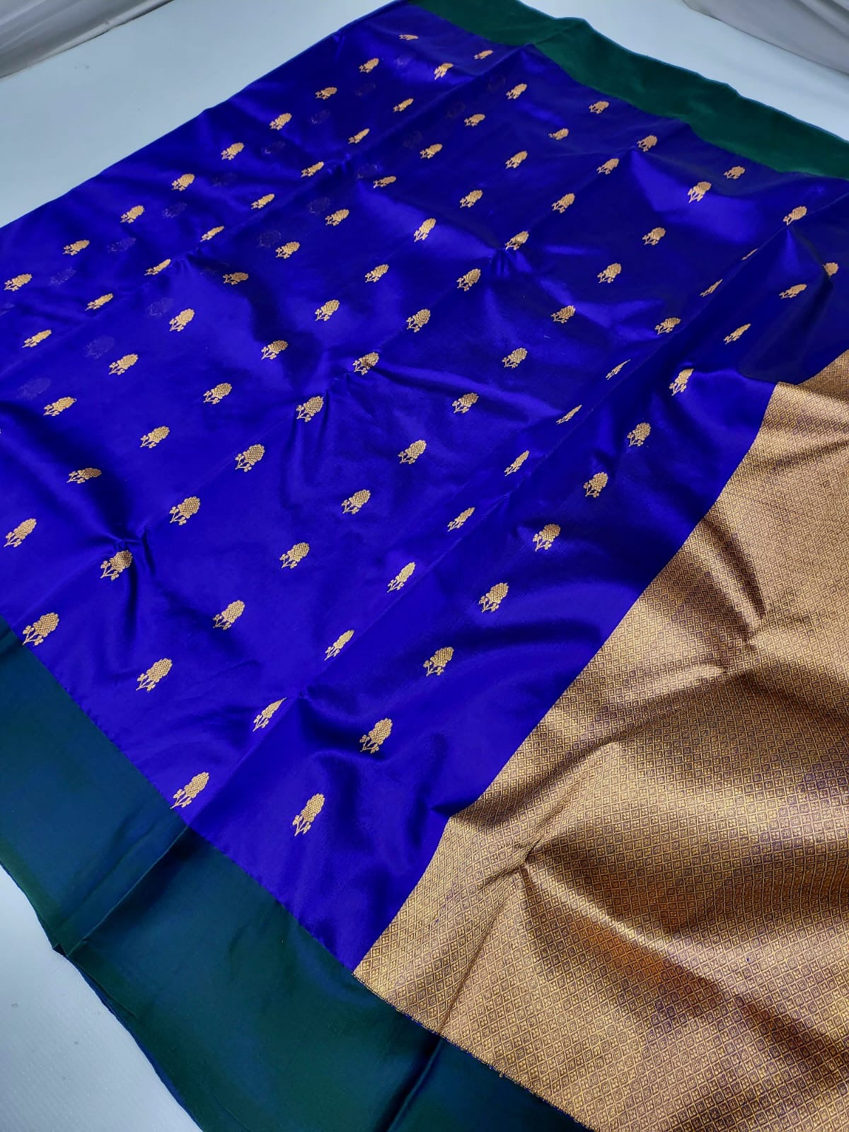 Royal blue body close-up showing gold floral cluster butta