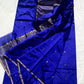 Folded royal blue Pattu Silk Chanderi handloom saree with small gold-toned buttas.