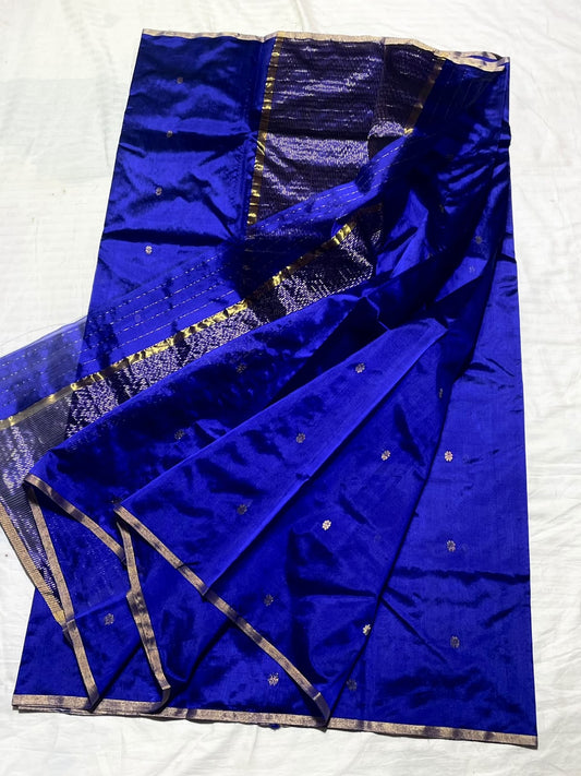 Folded royal blue Pattu Silk Chanderi handloom saree with small gold-toned buttas.