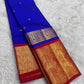 Neelam blue Pure Silk Kanjeevaram Butta saree with spaced gold-zari motifs and vermilion-red grand border.