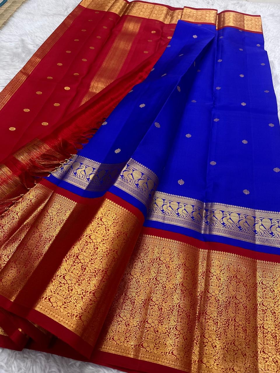 Royal Blue Kanchipuram silk body with small spaced circular gold zari buttas.
