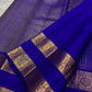 Royal blue Kancheepuram silk saree body close-up showing Zari Kattam luminous grid and Mayil Chakram gold zari butta motifs