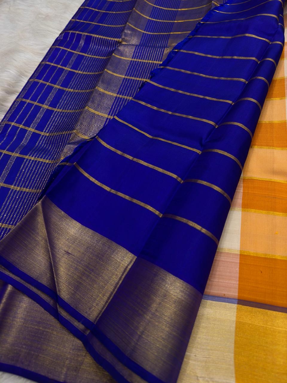 Mango Yellow and Royal Blue Lightweight Kanjivaram Kattam Saree with Seer Pallu showing gold zari stripes