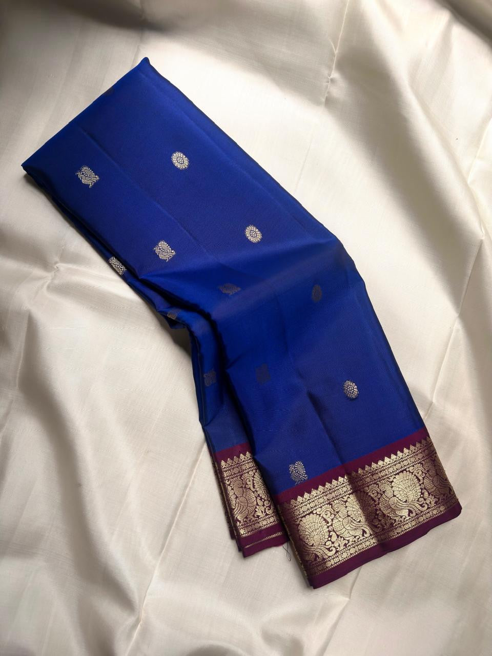 Royal Blue pure silk Kanjivaram Butta saree with Vadamalli Purple contrast border.