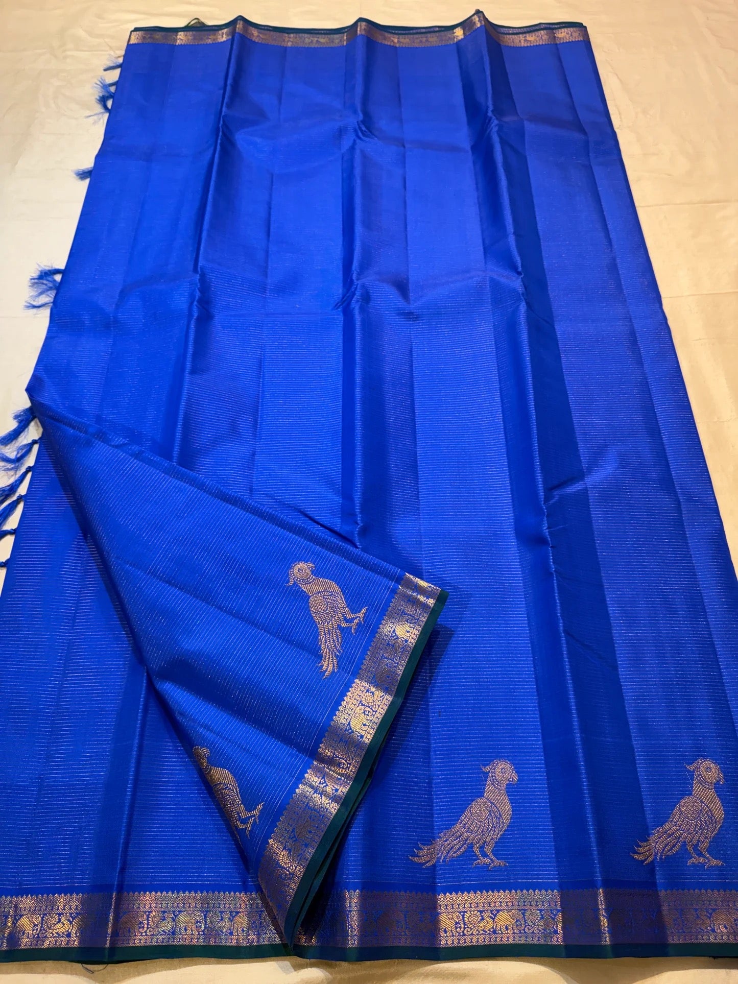 Teal zari border detail on a royal blue Kanjeevaram Vairaoosi saree