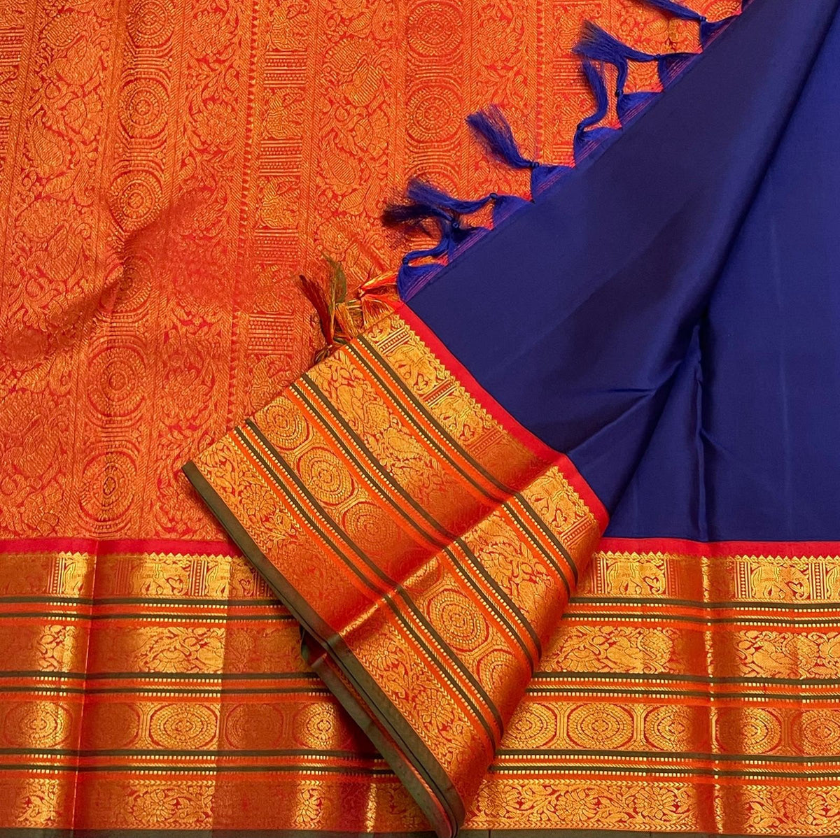 Royal-blue Pure Silk Kanjivaram Varisaipet saree with a burnt-orange contrast border and classic-gold zari.