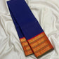 Burnt-orange Kanchipuram pallu with dense vertical classic-gold zari registers and ornamental woven forms.