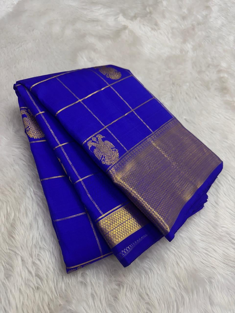 Royal Blue Kanchipuram silk saree with antique gold Zari Kattam body and broad zari border, full drape view.