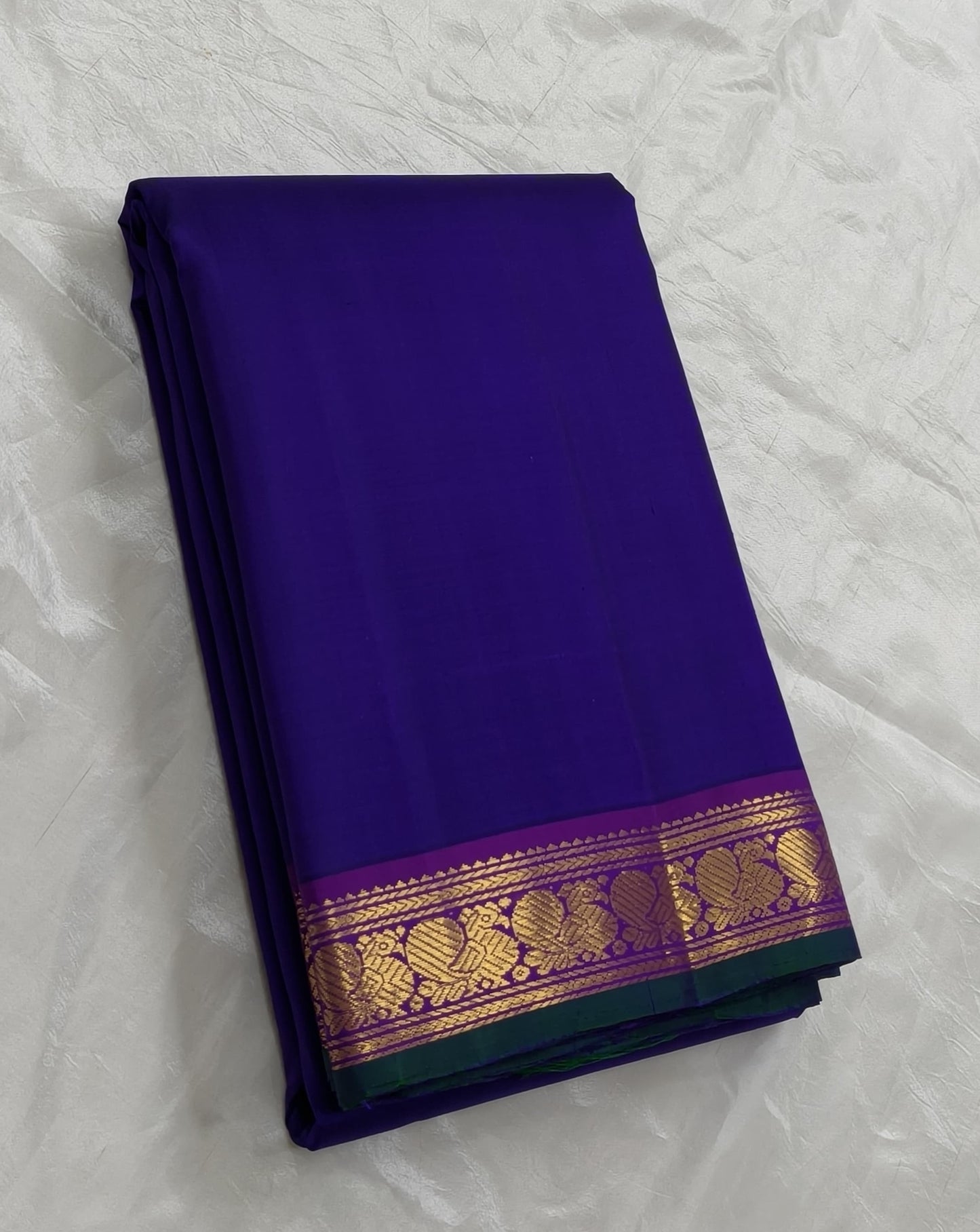 Royal indigo Kanjivaram silk saree with magenta mayil border – full length view