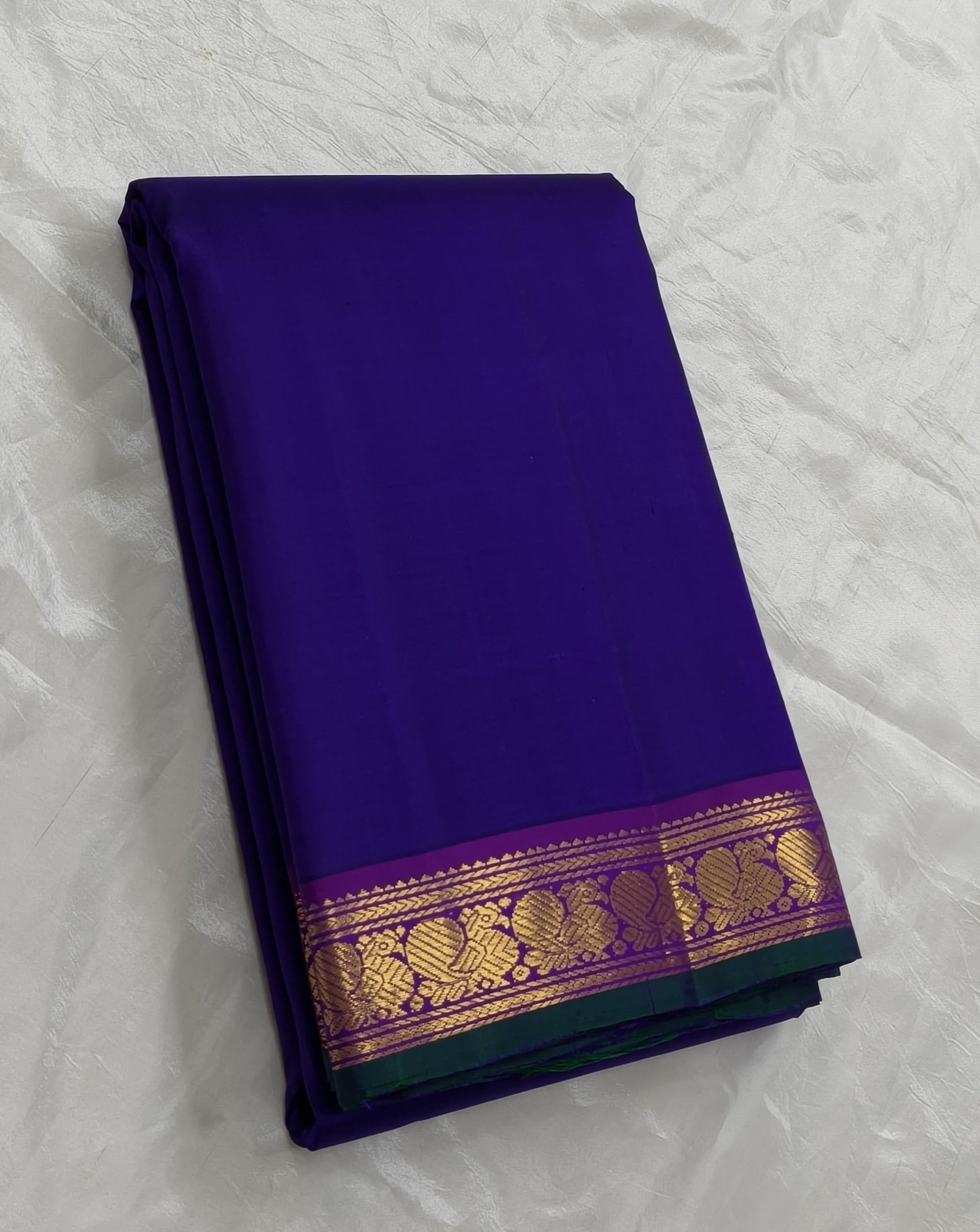 Royal indigo Kanjivaram silk saree with magenta mayil border – full length view