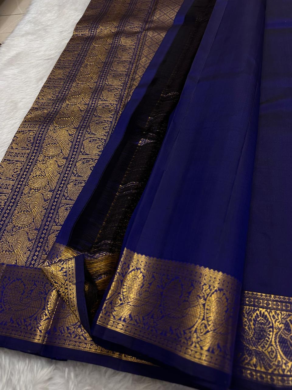 Traditional Kanchipuram silk saree showcasing royal blue silk and heritage peacock zari craftsmanship