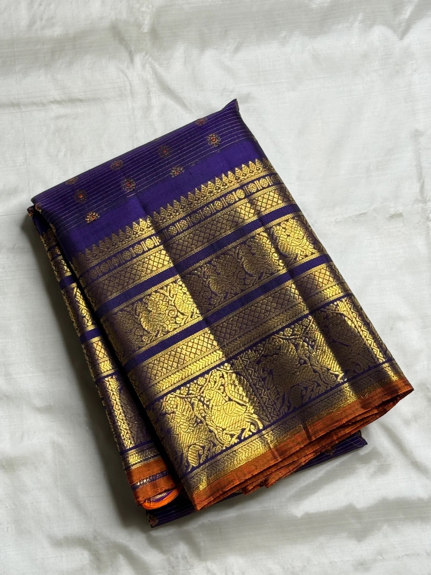 Full Royal Indigo Violet Vairaoosi saree showing gold buttas, broad zari borders and Burnt Orange edge