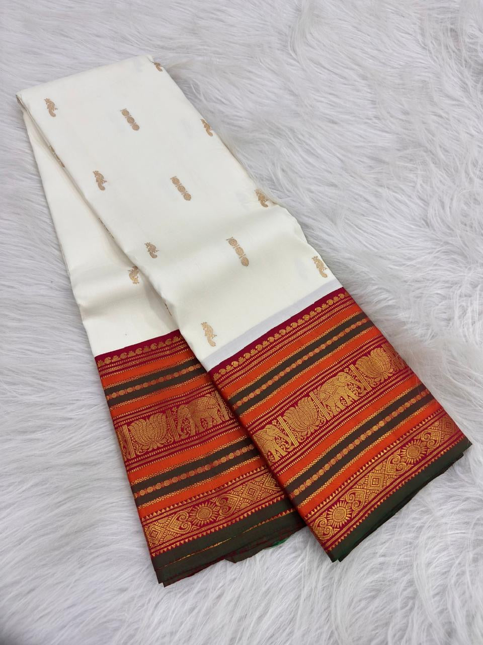 Close-up of pillar box red and burnt orange Varisaipet border on Royal Ivory Kanchipuram saree