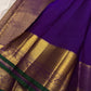 Purple pure silk Kanjivaram Butta saree with broad antique-gold zari border.