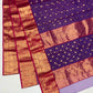 Draped Royal Purple handloom Chanderi showing gold floral buttas and broad decorative gold border framed in Rani Pink.