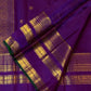 Close view of royal violet Zari Kattam silk framed by a multi-register gold border and deep-green selvedge.