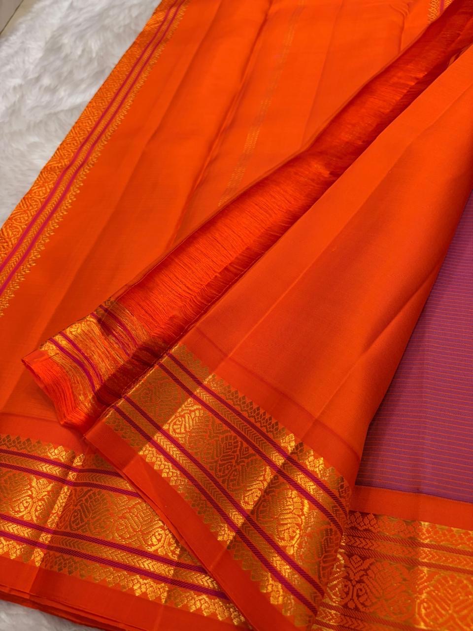 Gold zari border detail on royal purple KanchiPattu saree