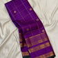 Royal purple Pure Silk Kanjivaram Zari Kattam saree folded with antique-gold Varisaipet border and green edge.