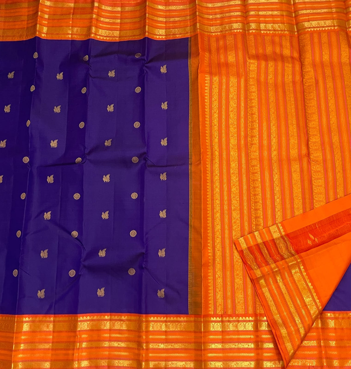 Handwoven purple Kanchipuram silk saree with orange Korvai border and antique gold zari