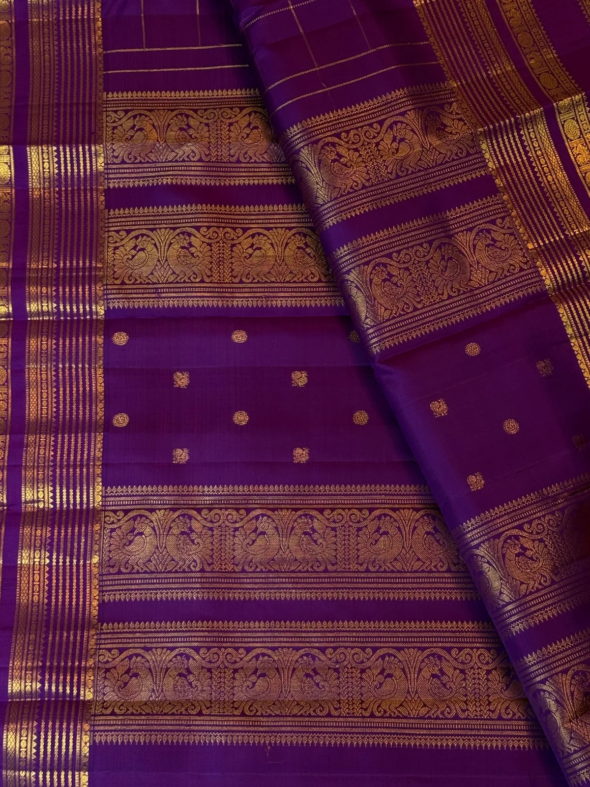 Royal violet-purple Kanchipuram silk body showing fine gold zari grid with spaced small antique-gold buttas.