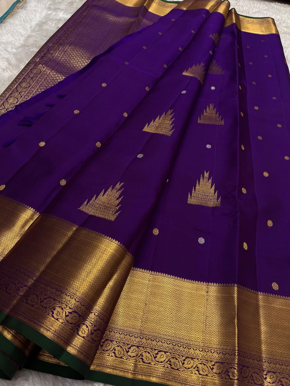 Royal Purple pure silk Kanjivaram Butta saree with traditional Thazhampoo Reku zari motifs.