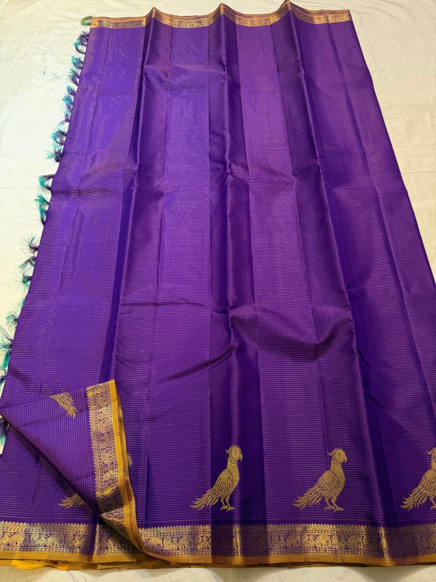 Close view of large antique-gold traditional bird motif on Royal Violet Kanchipuram silk.