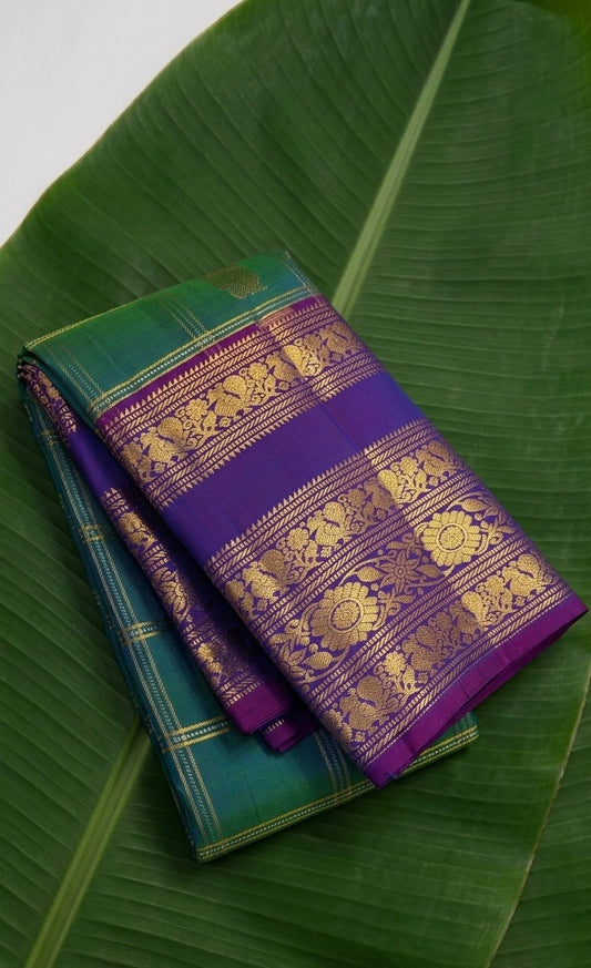 Kanchipuram silk saree in peacock green with royal purple border Varisaipet Korvai weave folded view