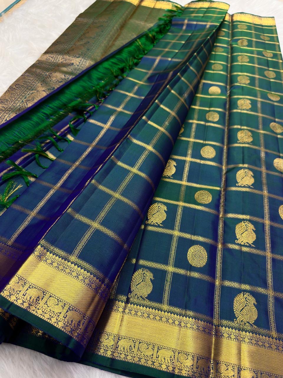 Royal teal blue Zari Kattam Kanjeevaram saree with Mayil Chakram, folded view
