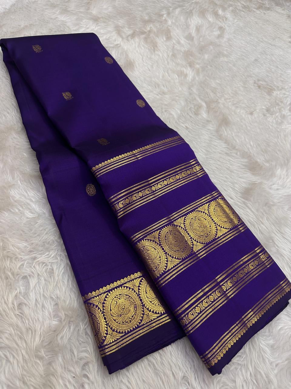 Royal violet handwoven Kanchipuram silk saree with Rettapet border, full drape view.