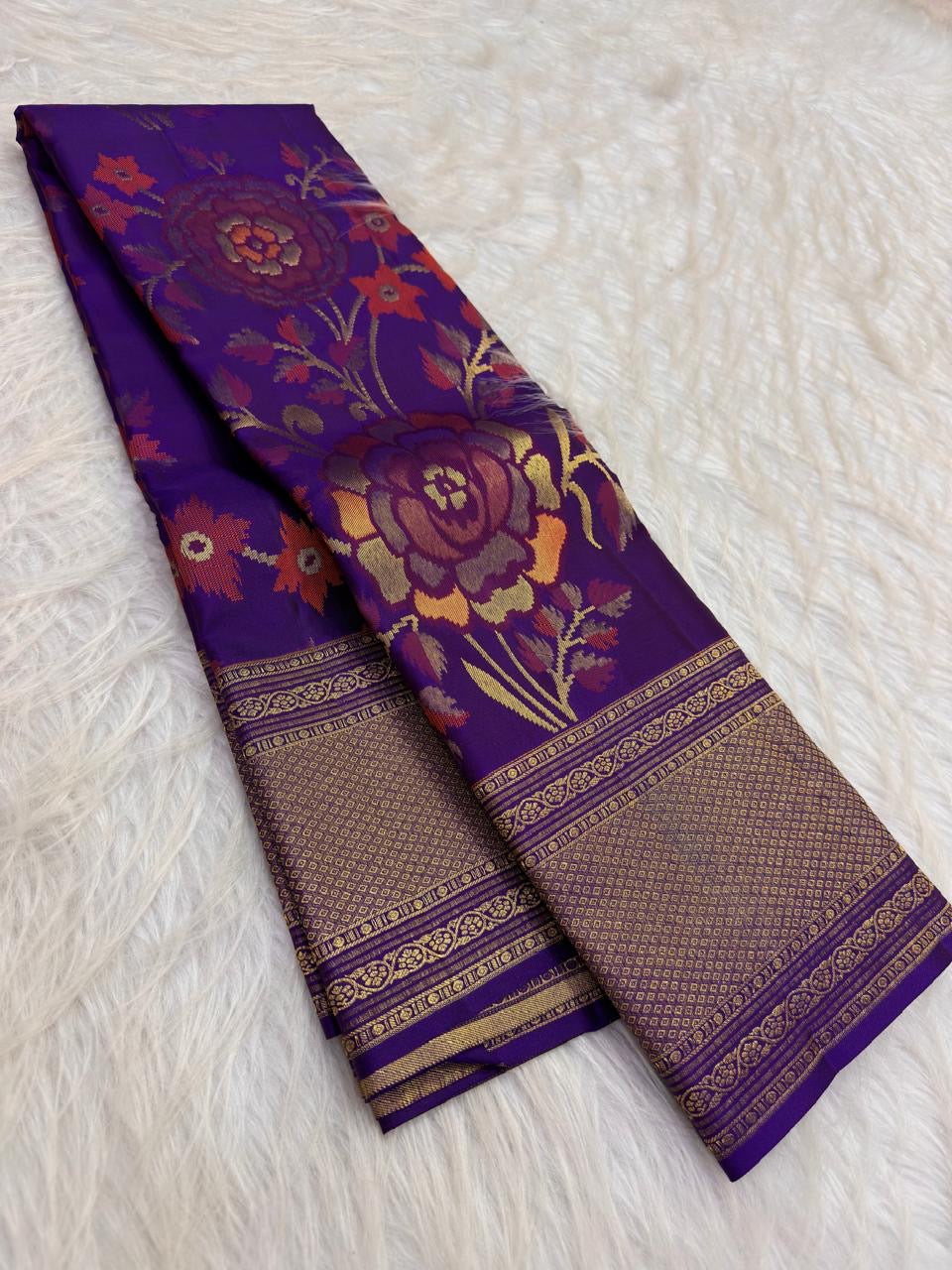 Handwoven purple Kanchipuram saree with large floral jaal in burnt orange rose sage and gold.