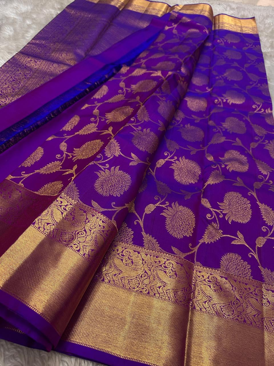 Royal violet Kanchipattu handwoven pure silk saree, folded view with floral jaal border.