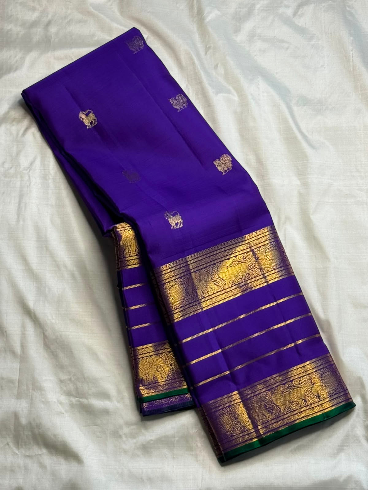 Close-up of yazhi butta in gold zari on royal violet Kanchipuram silk saree — Idam Living