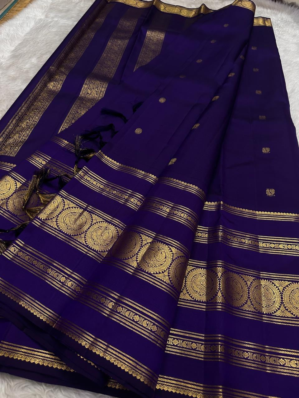 Royal violet Kanjivaram pure silk saree, close view of the zari medallion border.