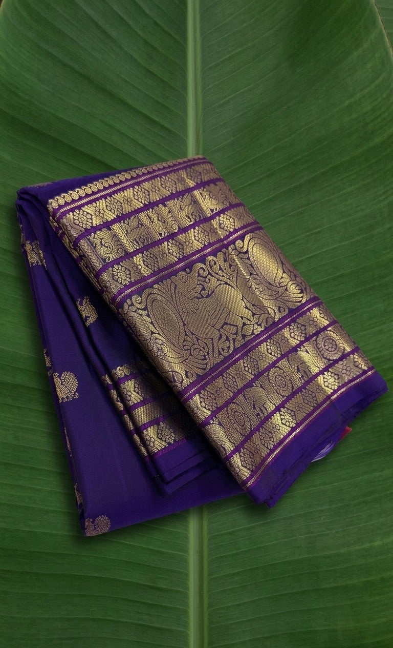 Pure Kanchipuram Korvai silk saree in royal violet purple with Gandaberunda zari border and gold buttas