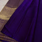 Close view of multicolour floral zari jaal woven across saturated Royal Violet Kanchipuram silk.