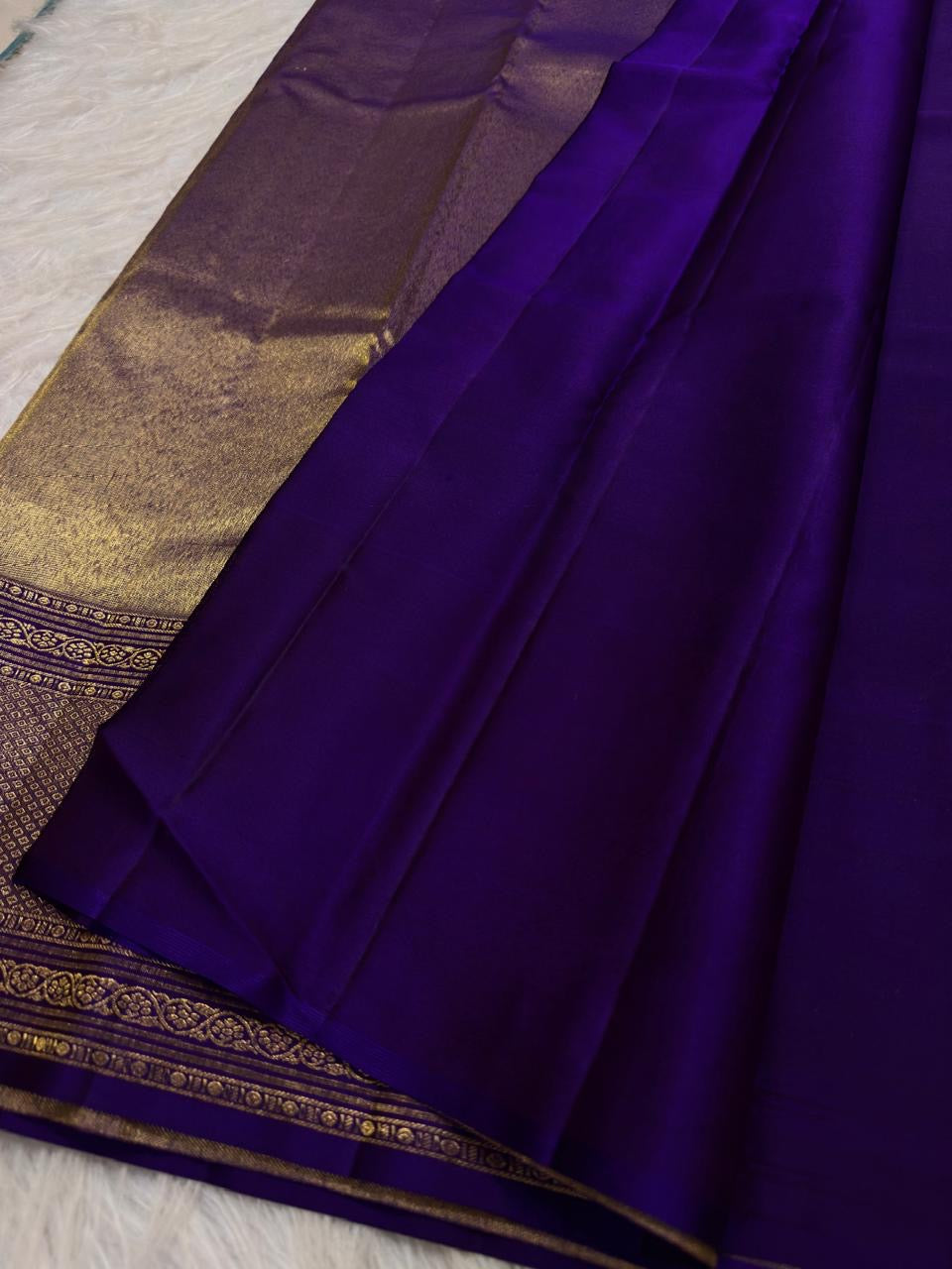 Close view of multicolour floral zari jaal woven across saturated Royal Violet Kanchipuram silk.