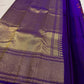 Purple Kanchi Pattu saree with large coral orange sage and gold handwoven floral motifs.