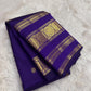 Royal violet pure silk Kanjipuram Rettapet saree showing the zari medallion border detail.