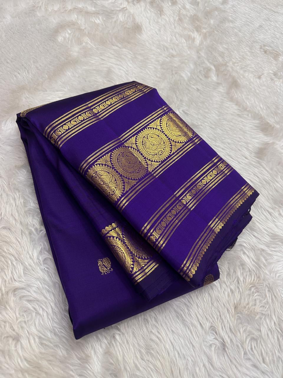 Royal violet pure silk Kanjipuram Rettapet saree showing the zari medallion border detail.