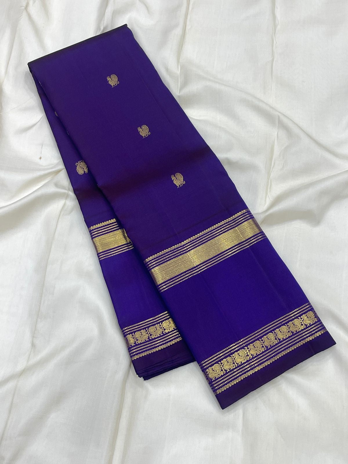 Royal Violet Purple Kanchipuram silk body with alternating small gold zari motifs.
