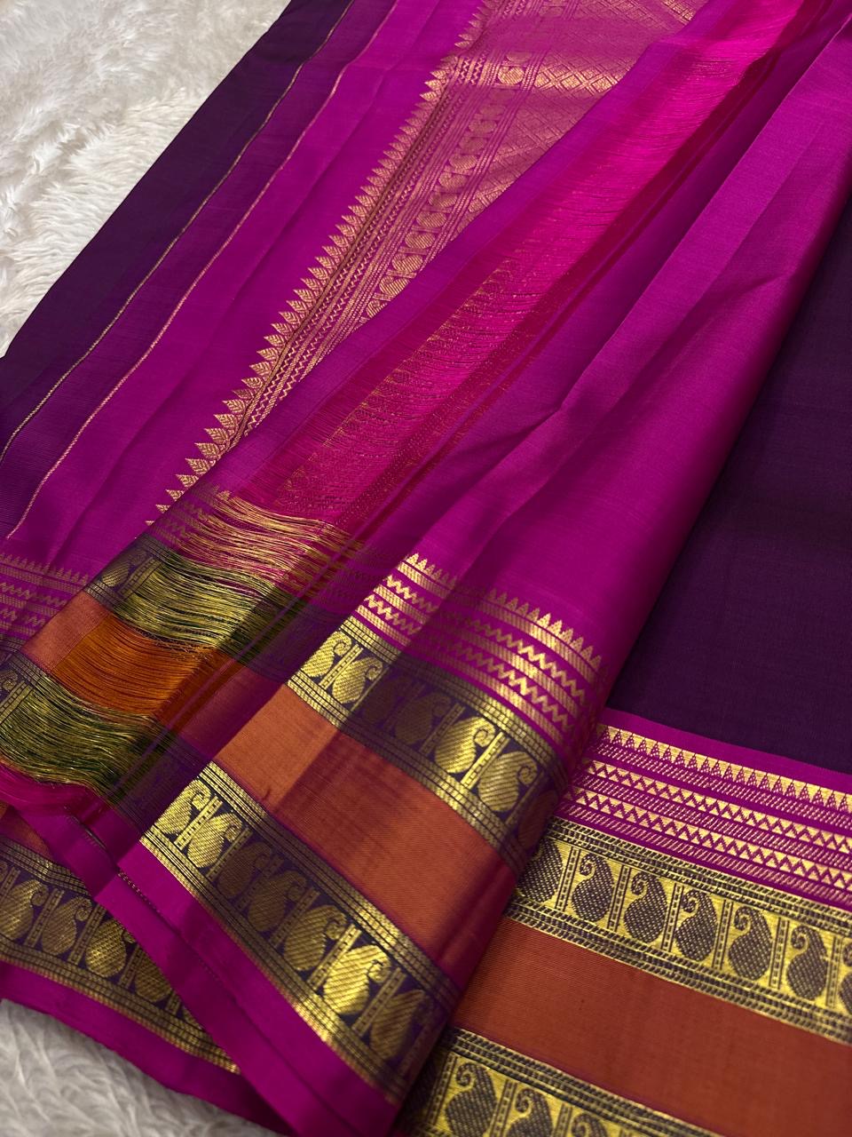 Royal aubergine Kanjipuram pure silk saree draped, showing Rettapet twin border
