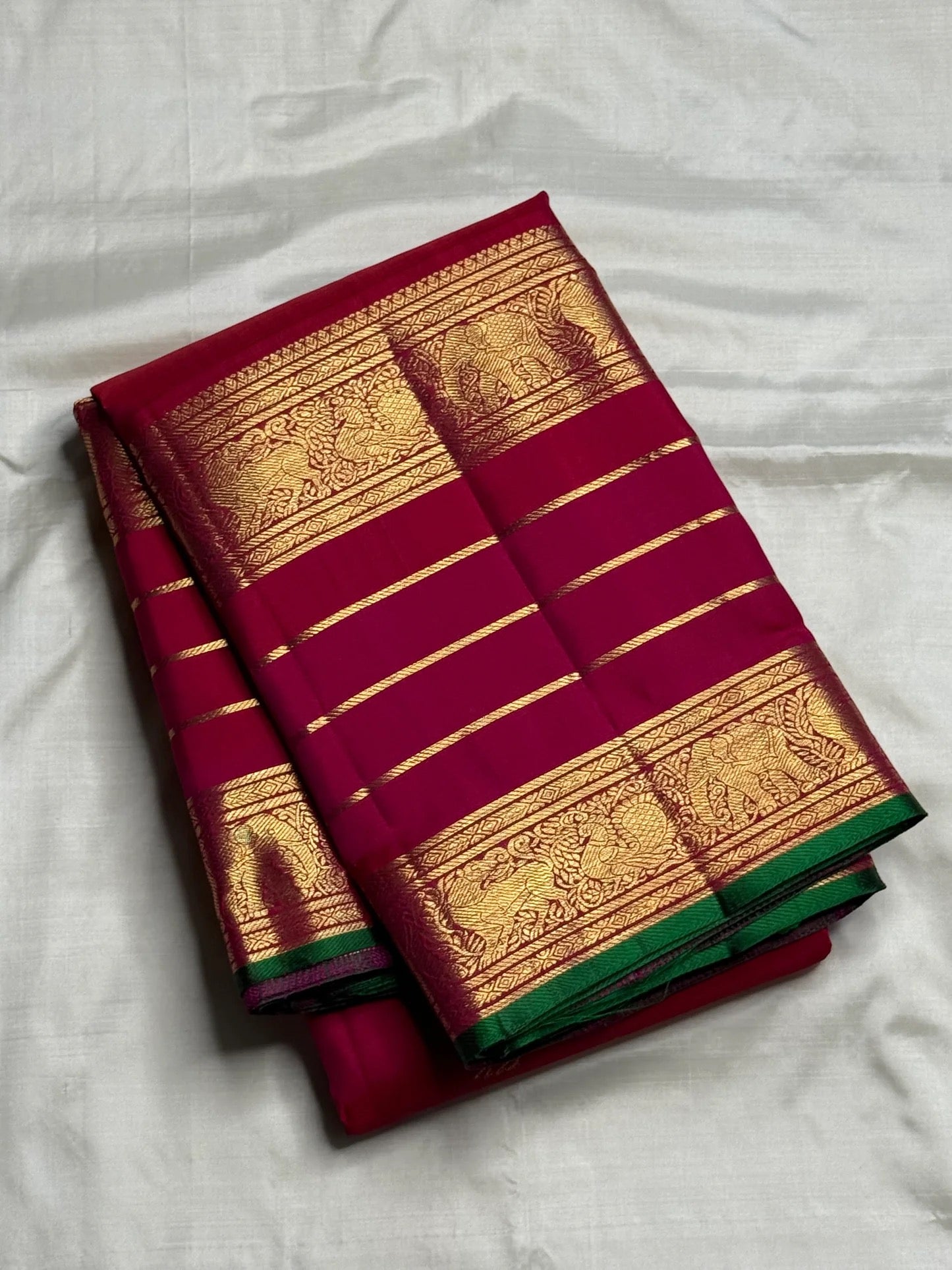 Luxury ruby berry silk saree with richly woven traditional zari border.