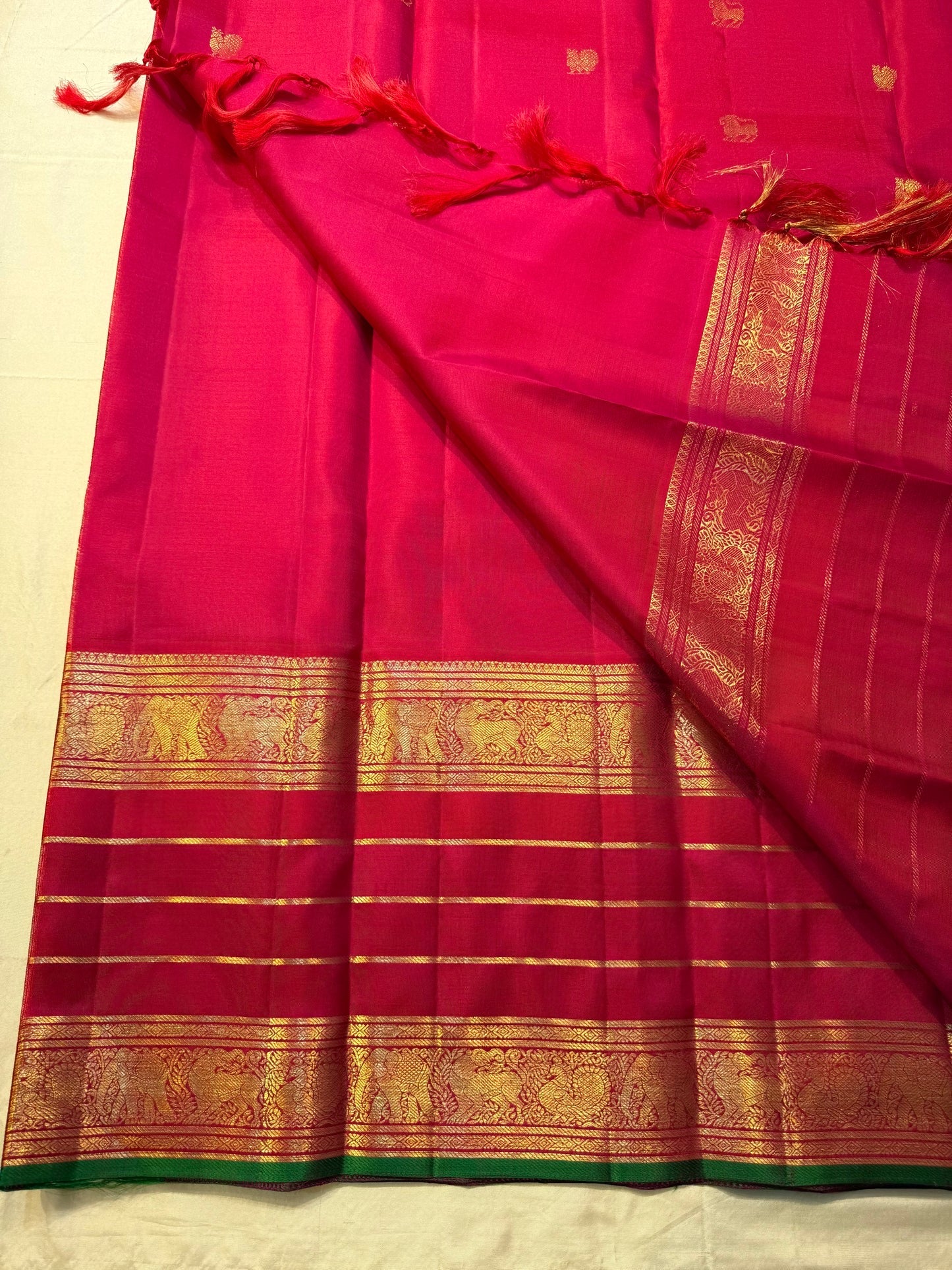 Traditional Kanchipuram silk saree with mayil and yazhi butta motifs.