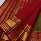 Rich ruby red border with bold circular zari medallions on a green silk saree