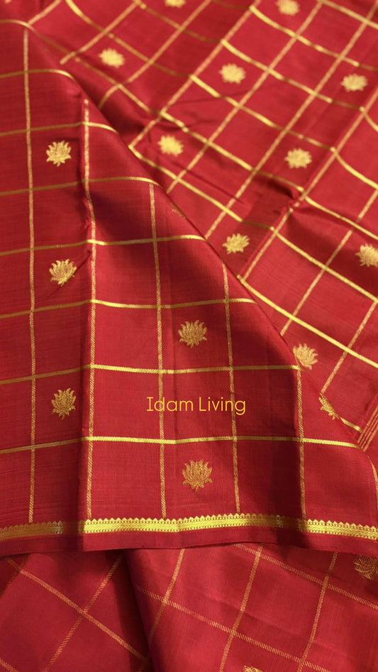 Deep red Kanchipuram silk saree with traditional gold zari kattam checks and lotus butta motifs
